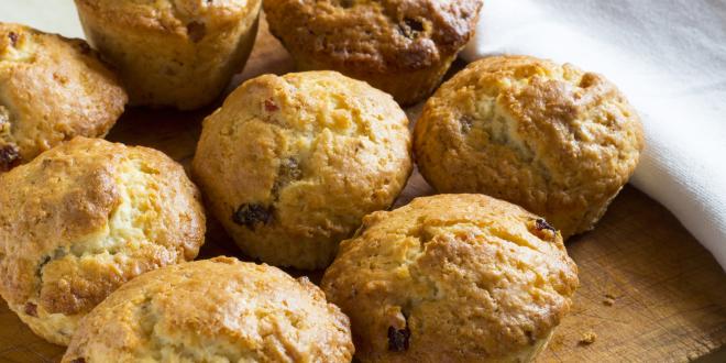 A cluster of seven muffins on a serving board.